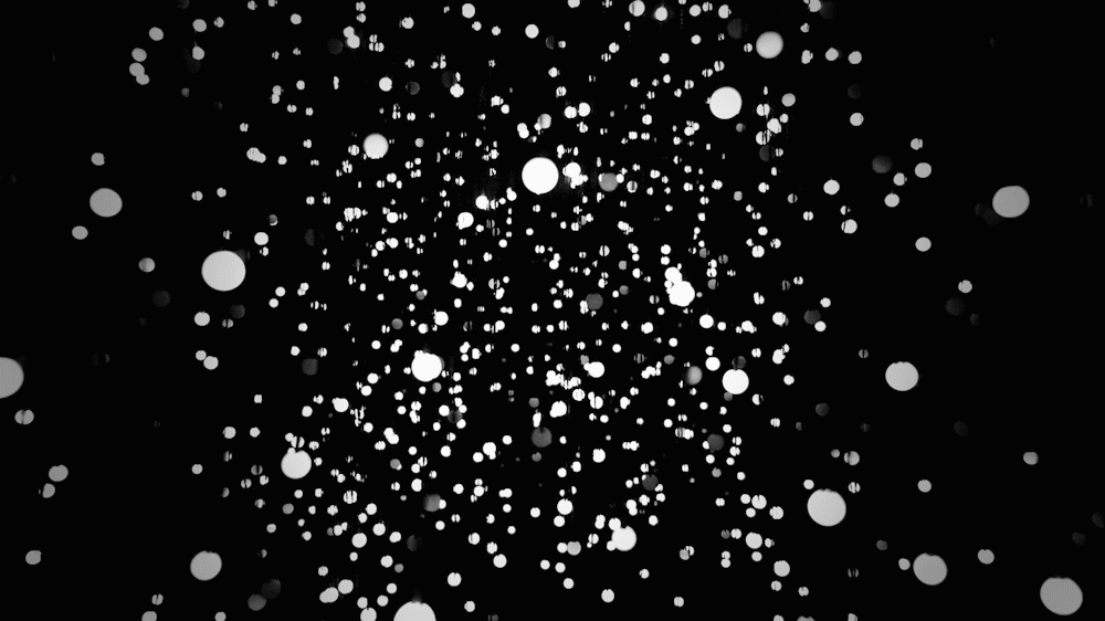 Animación de la obra Exploded Views de Jim Campbell vista desde otro ángulo, donde los destellos LED generan una galaxia de puntos luminosos.
